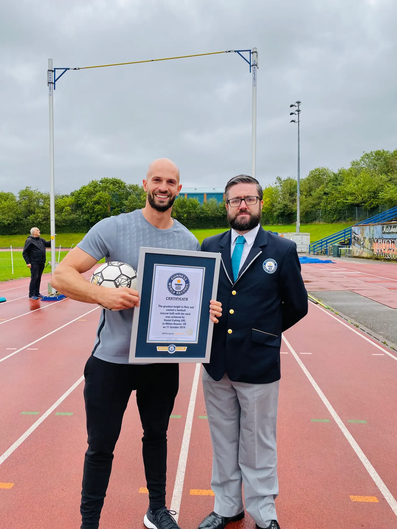 Daniel with an adjudicator and his Guinness World Records certificate