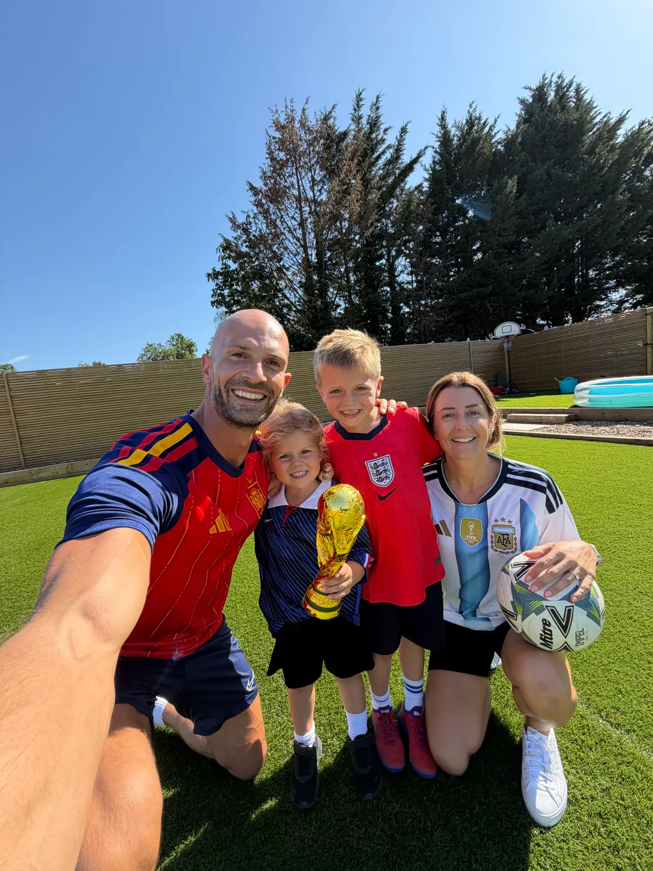 The family in their garden with a World Cup trophy